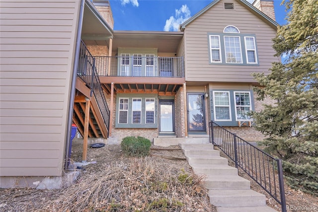 townhome / multi-family property featuring stairway and a chimney