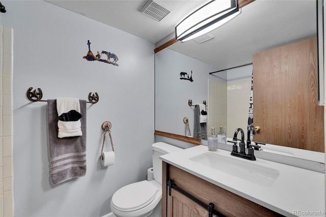 full bathroom featuring toilet, visible vents, a shower, and vanity