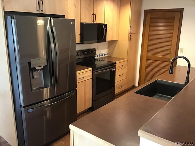 kitchen with stainless steel fridge, light brown cabinets, electric stove, a sink, and black microwave