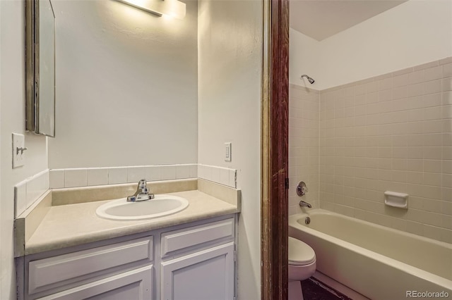 bathroom with toilet, shower / tub combo, and vanity