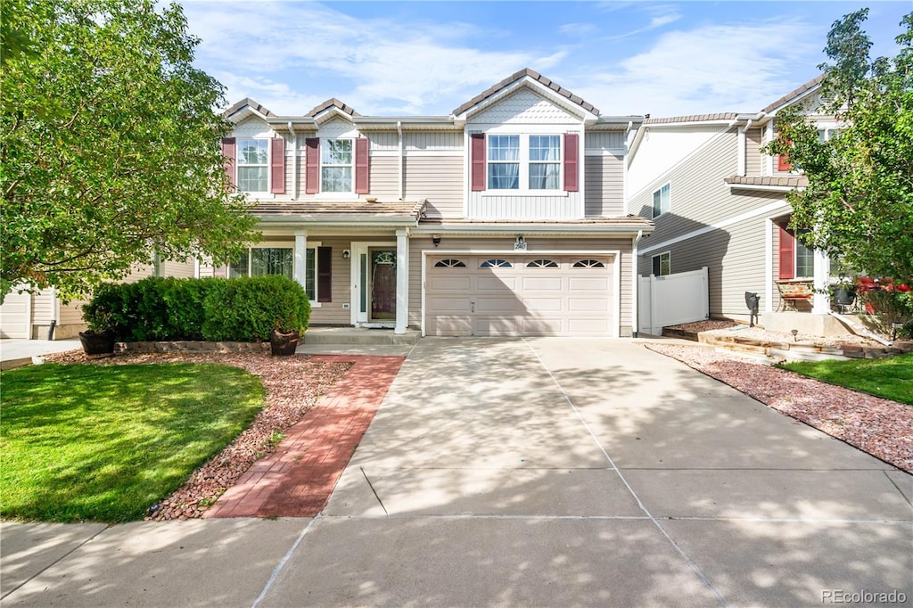 view of front of home with a garage and a front lawn