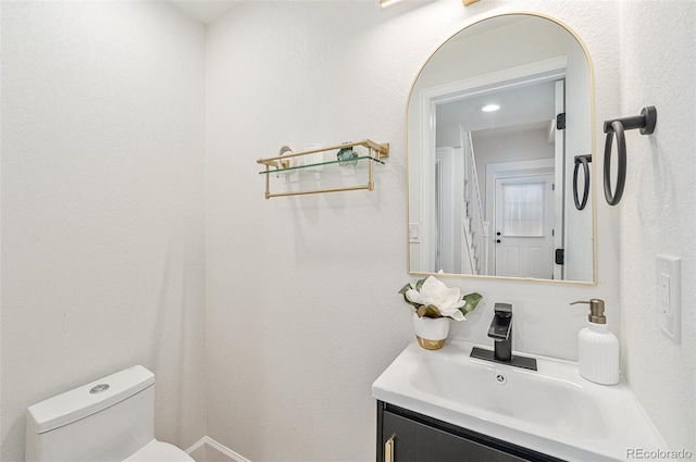 bathroom with vanity and toilet