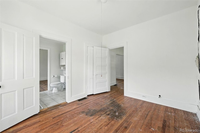 1914 Washington Ave, Golden, CO 80401 - unfurnished bedroom with dark wood finished floors and ensuite bath