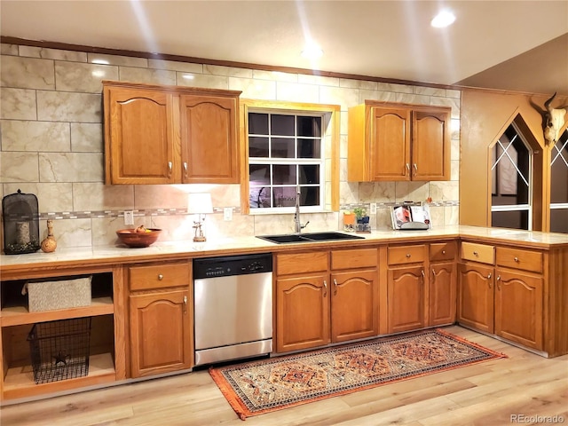 kitchen with dishwasher, backsplash, light hardwood / wood-style floors, and sink