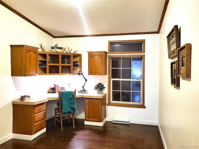 office with dark hardwood / wood-style flooring, built in desk, and ornamental molding