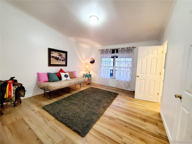 living room with hardwood / wood-style floors and crown molding