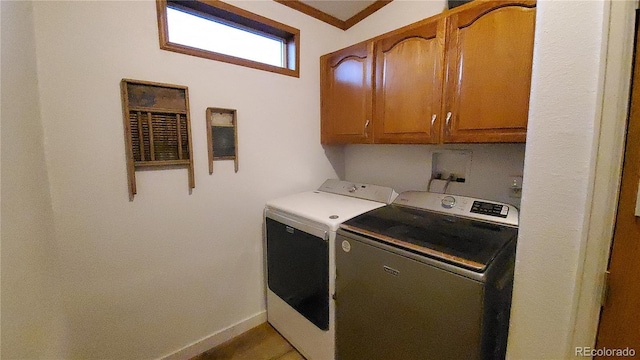 laundry room featuring cabinets and separate washer and dryer