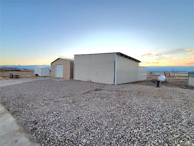 view of garage at dusk