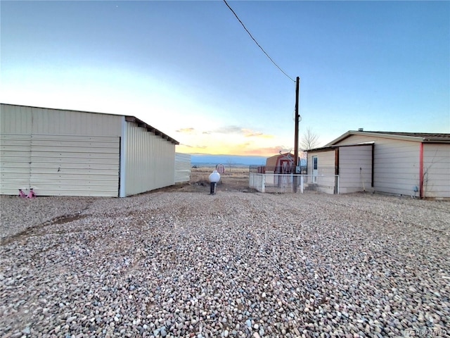 view of garage at dusk