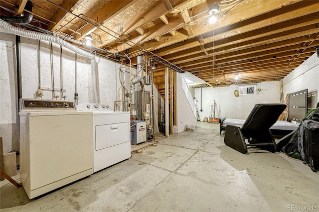 basement with washing machine and dryer and water heater