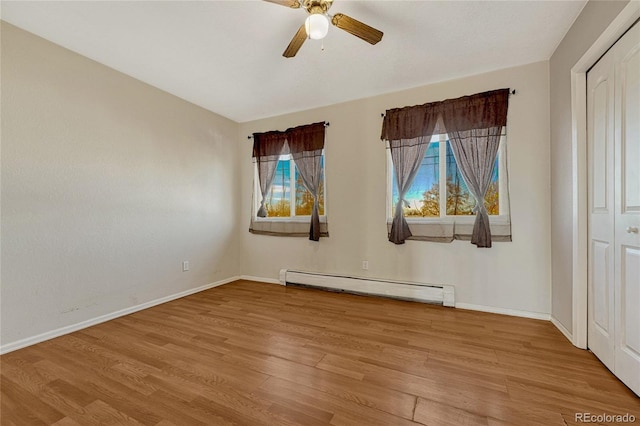 unfurnished bedroom with ceiling fan, light hardwood / wood-style flooring, and a baseboard radiator