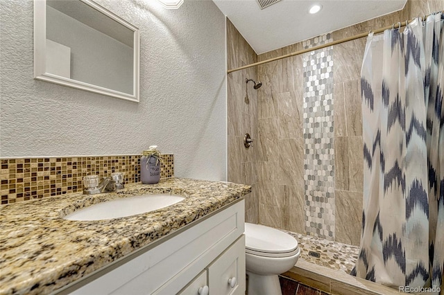 bathroom featuring walk in shower, a textured ceiling, toilet, decorative backsplash, and vanity