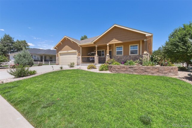 view of front of home with a garage and a front lawn