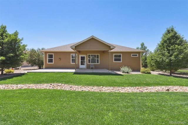 rear view of house with a patio area and a lawn