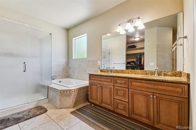 bathroom with tile patterned floors, vanity, and independent shower and bath