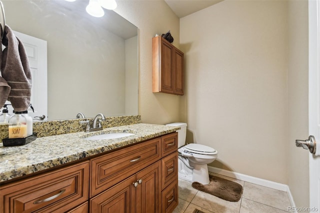 bathroom featuring vanity, toilet, and tile patterned flooring