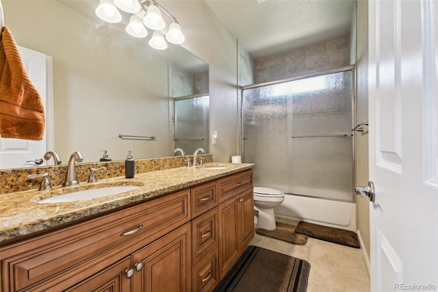 full bathroom featuring shower / bath combination with glass door, toilet, vanity, and tile patterned flooring