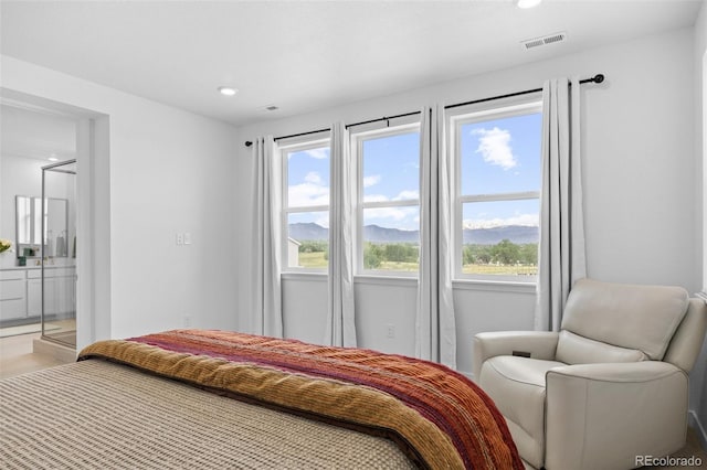 bedroom featuring visible vents, recessed lighting, ensuite bath, and light wood-style floors