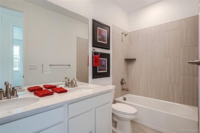 full bathroom featuring shower / bathing tub combination, toilet, double vanity, and a sink