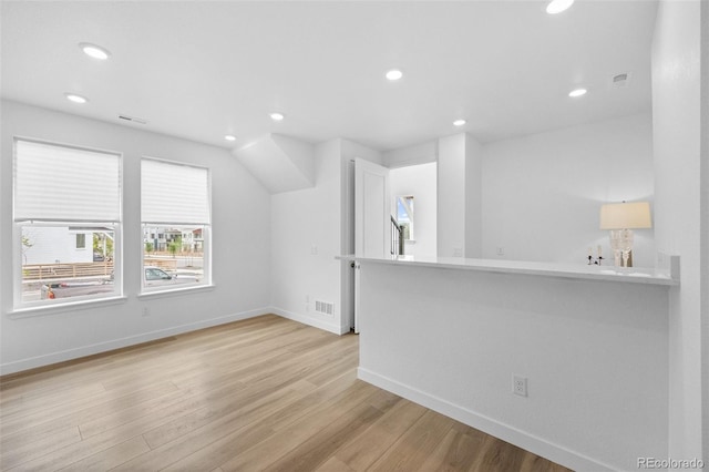 interior space featuring recessed lighting, light wood-style floors, visible vents, and baseboards