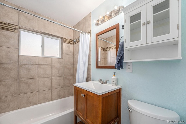 full bathroom with shower / bathtub combination with curtain, vanity, and toilet