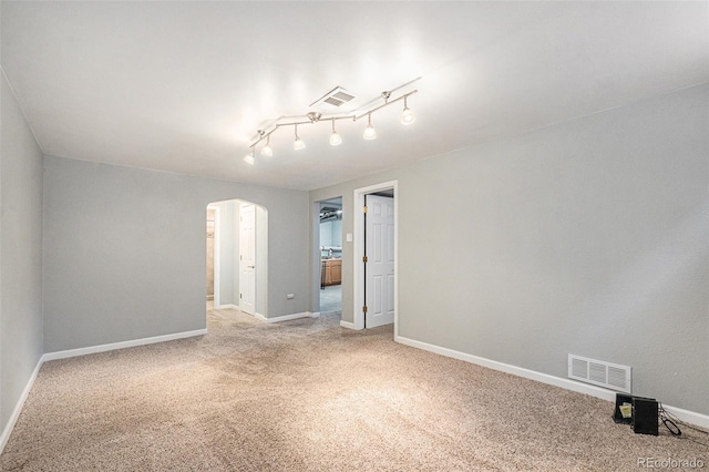 unfurnished room with carpet floors and track lighting