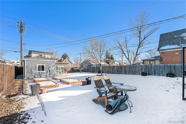 yard covered in snow featuring a storage unit