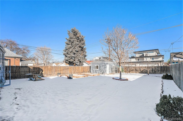 yard covered in snow with an outdoor structure