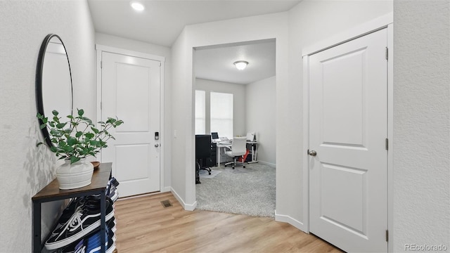 interior space with visible vents, light wood-style flooring, baseboards, and recessed lighting