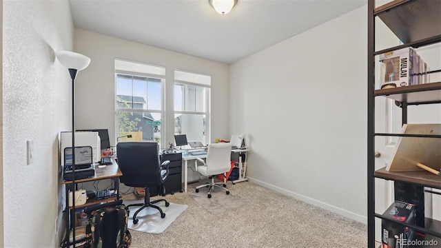 carpeted home office with baseboards