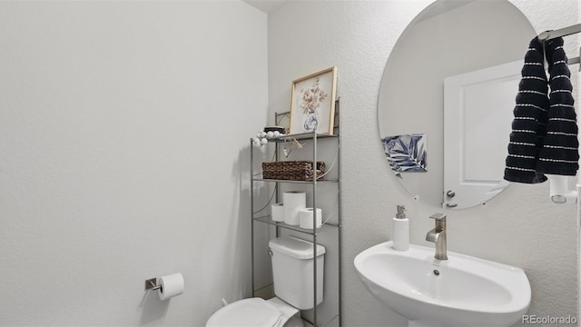 half bathroom with toilet and a sink
