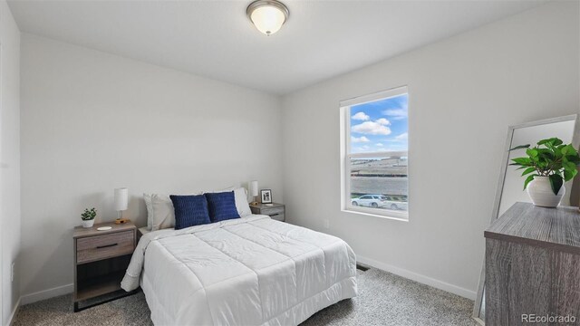 bedroom featuring carpet floors and baseboards