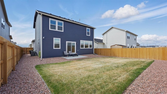 rear view of property featuring a yard, central air condition unit, a patio, and a fenced backyard