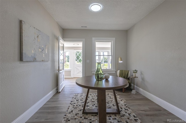 5195 Allison St, Arvada, CO 80002 - dining space with a textured ceiling, wood finished floors, and a textured wall
