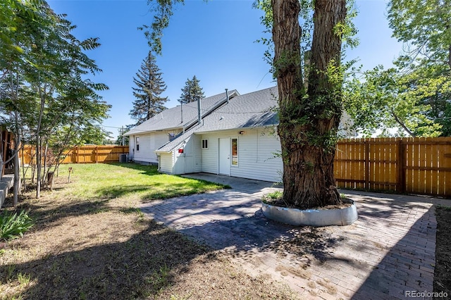 5195 Allison St, Arvada, CO 80002 - back of property featuring a patio, a fenced backyard, and roof with shingles