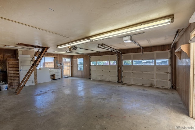 5195 Allison St, Arvada, CO 80002 - garage with a garage door opener and wood walls