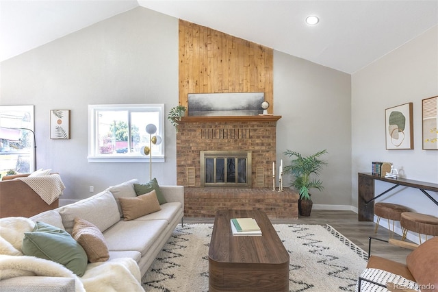 5195 Allison St, Arvada, CO 80002 - living room featuring high vaulted ceiling, wood finished floors, a brick fireplace, and recessed lighting