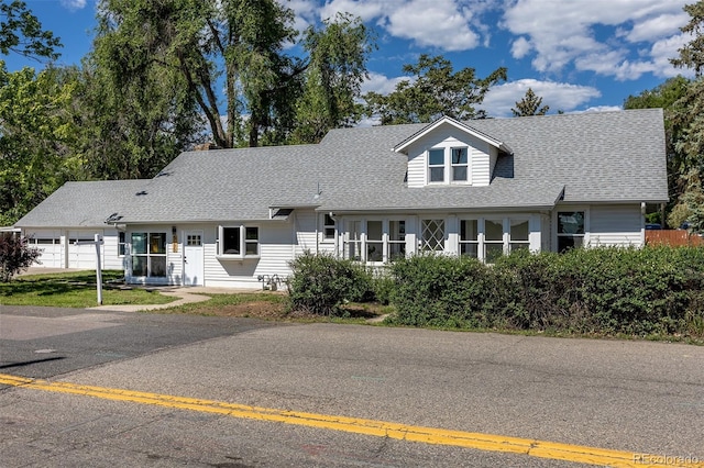 5195 Allison St, Arvada, CO 80002 - new england style home featuring a shingled roof