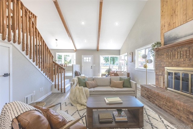 5195 Allison St, Arvada, CO 80002 - living area with wood finished floors, stairs, and a fireplace