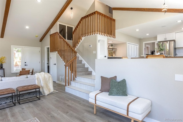 5195 Allison St, Arvada, CO 80002 - stairway with plenty of natural light, wood finished floors, high vaulted ceiling, beam ceiling, and recessed lighting