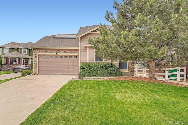 23882 E Alabama Dr, Aurora, CO 80018 - view of front facade featuring solar panels, concrete driveway, an attached garage, stone siding, and roof with shingles