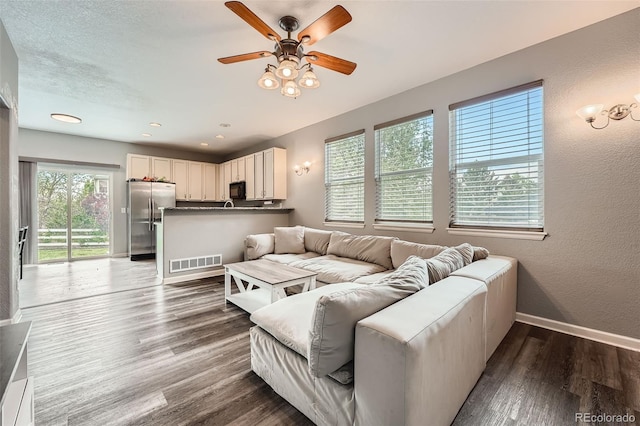 23882 E Alabama Dr, Aurora, CO 80018 - living room featuring baseboards, ceiling fan, wood finished floors, and a textured wall