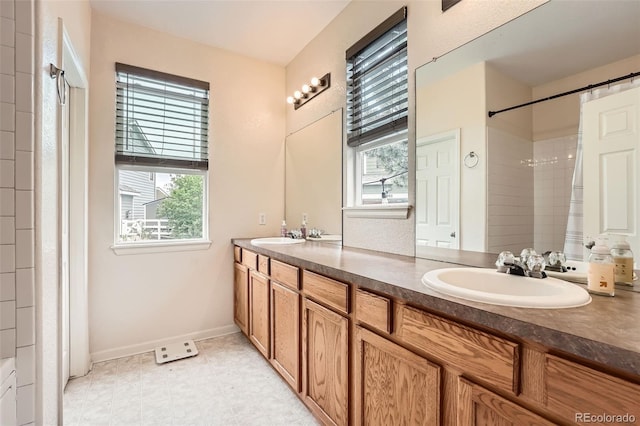 23882 E Alabama Dr, Aurora, CO 80018 - bathroom with plenty of natural light, double vanity, baseboards, and a shower with shower curtain