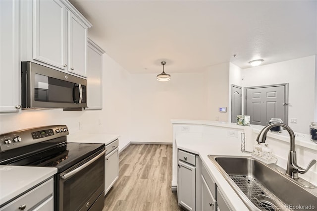 18657 Stroh Rd Unit 4103, Parker, CO 80134 - kitchen featuring stainless steel appliances, a sink, light countertops, and light wood-type flooring