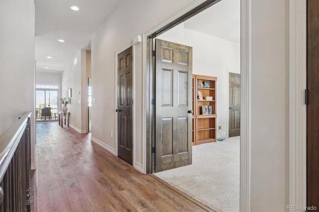 corridor with hardwood / wood-style flooring