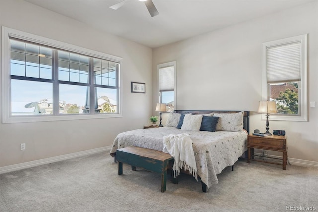 bedroom with light colored carpet and ceiling fan