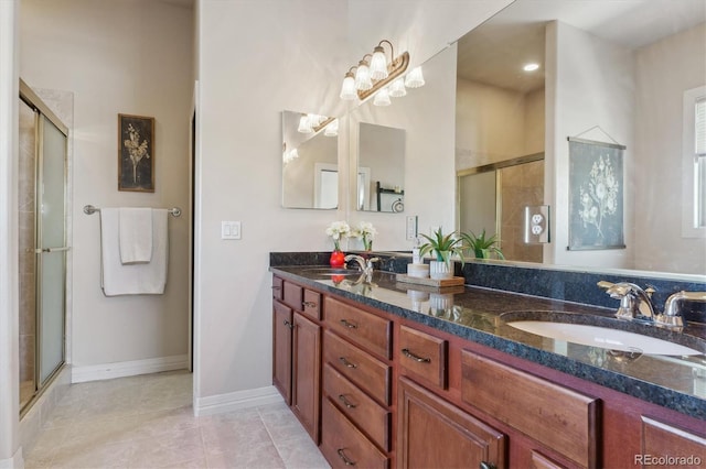 bathroom with tile patterned flooring, an enclosed shower, and vanity