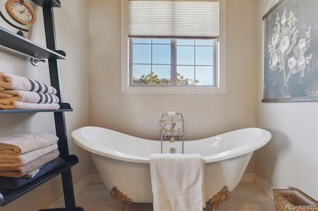 bathroom with a tub and tile patterned floors