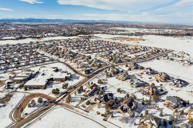 snowy aerial view with a mountain view