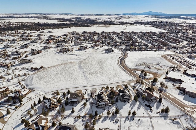 snowy aerial view with a mountain view